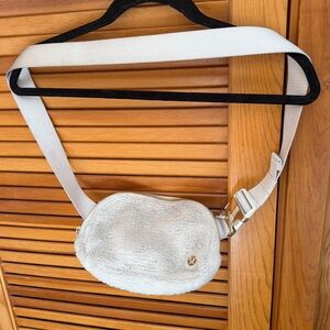 Lululemon Cream Crossbody Bag with gold accents